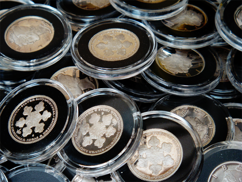 Many Silver Snow Crystals in Capsules arranged over each other.